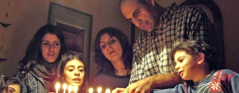 family lighting menorah