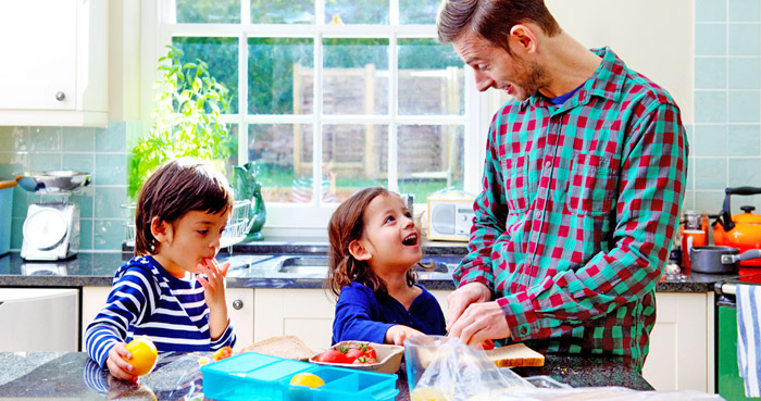 Dad and kids making lunch for school