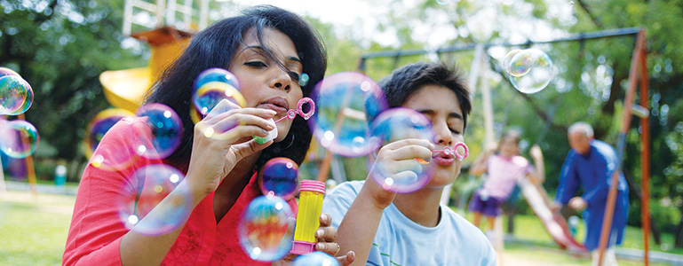Mother and child blowing bubbles