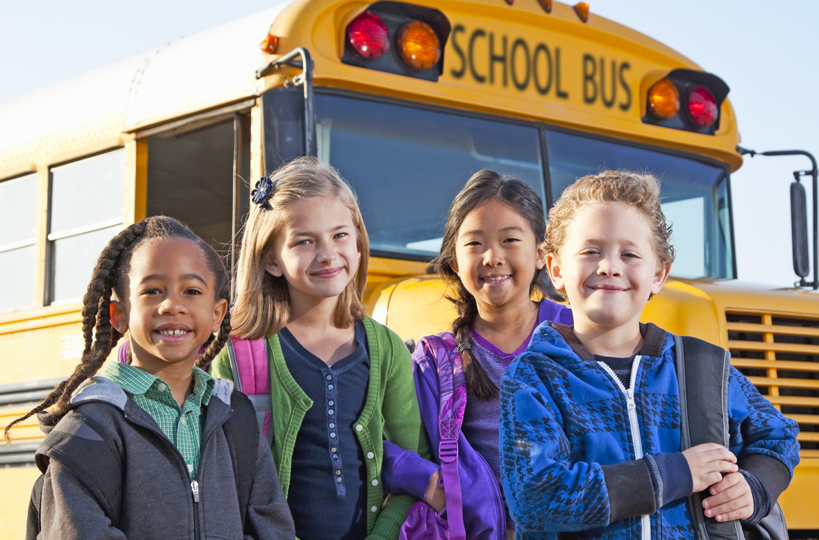children in front of school bus