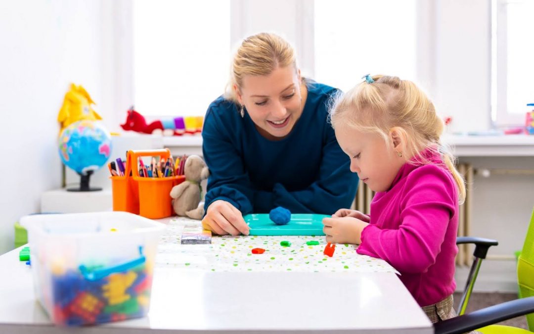 Toddler girl receiving Occupational Therapy with playful sensory exercises