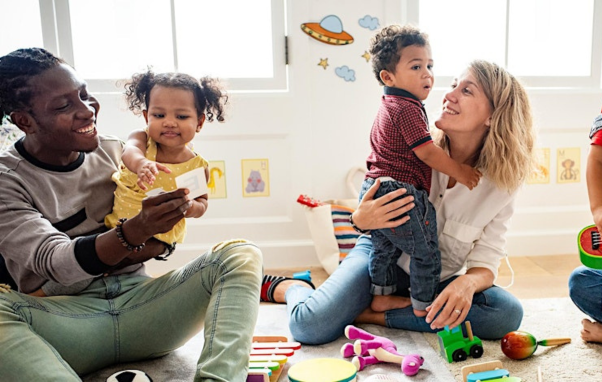 Kids playing with adults in a modern indoor playroom