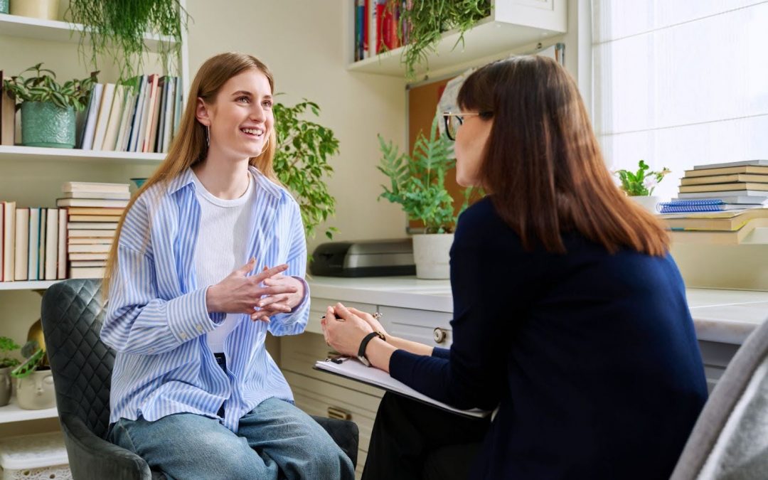 Smiling teen discussing mental wellness with therapist