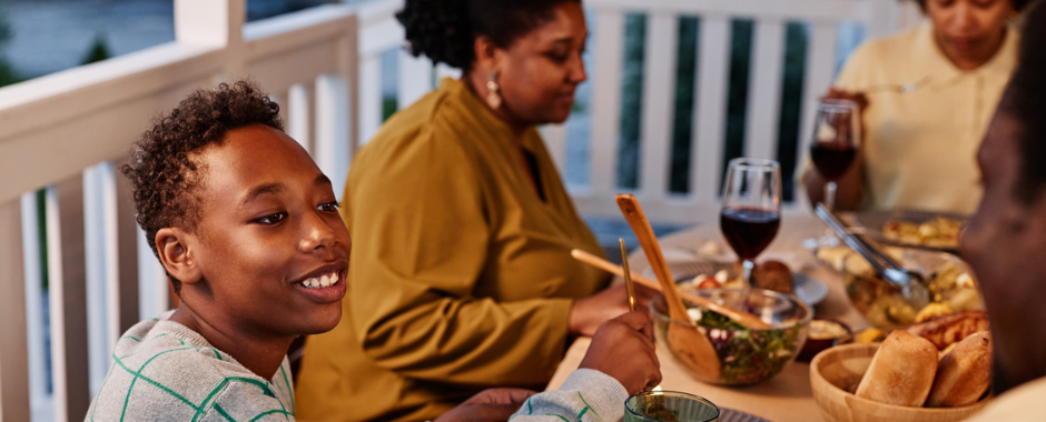 A family enjoying dinner around a table outdoors