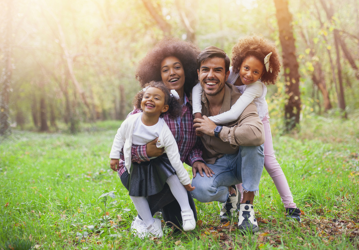 Happy mixed race family smiling on the outdoors family