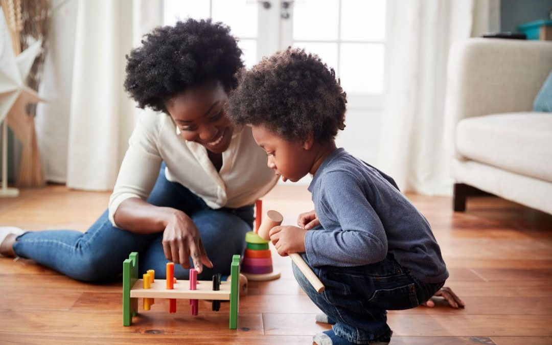 Mother and young son playing with brain exercise toy together