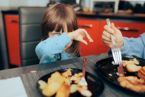Little child rejecting hating bad boring food option for lunch