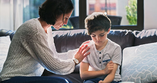 a mother emotionally supporting her young son with childhood anxiety